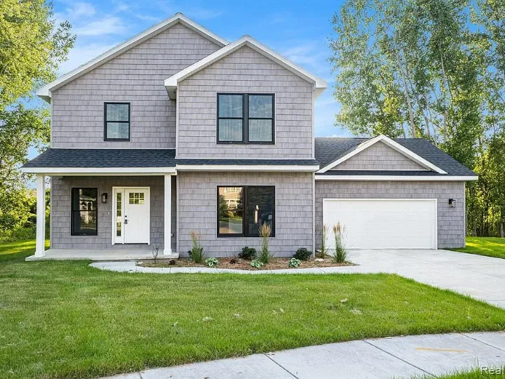 Two-story home with gray siding, a covered front porch, and an attached garage